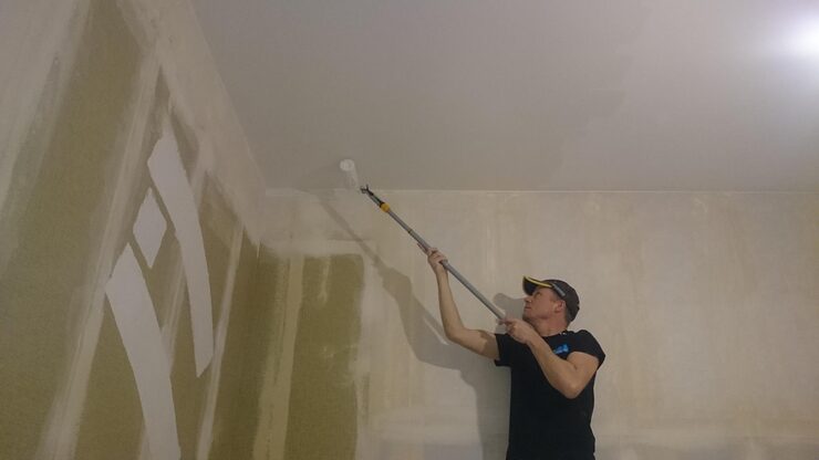 man painting ceiling