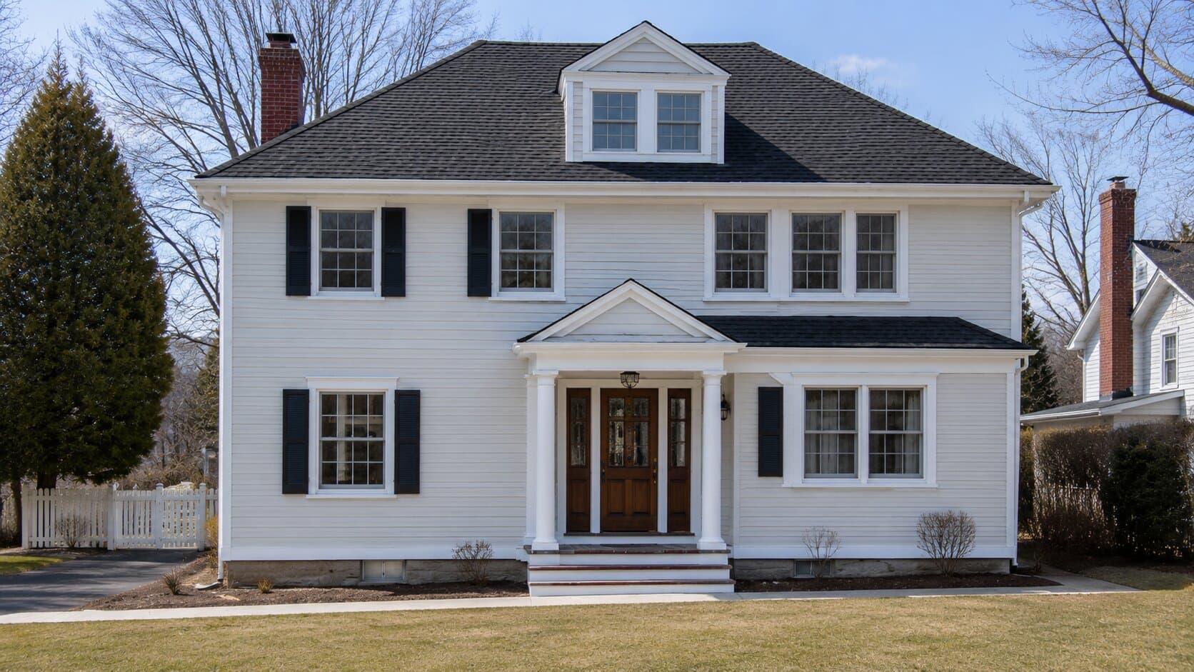 Completed exterior paint job on a white colonial-style house.