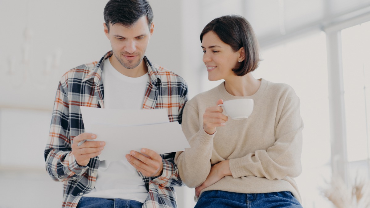 Man reviewing papers beside a woman