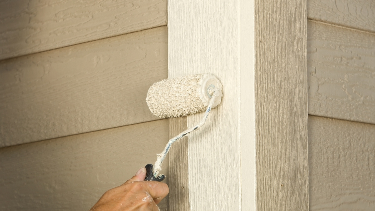 small paint roller to apply off-white or beige exterior paint